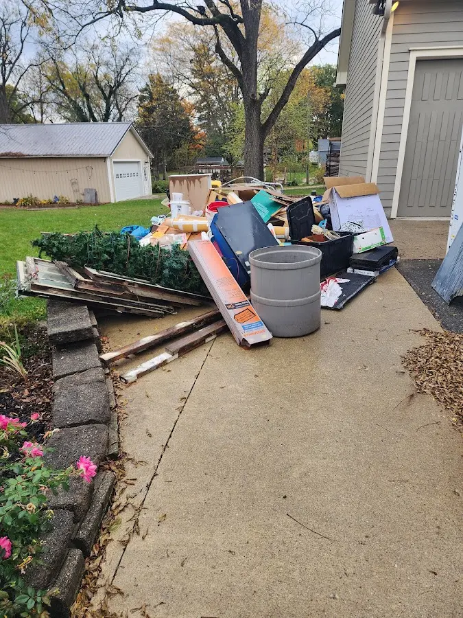 Dumpster being loaded with debris for Estate Cleanout Dumpster Rental in Baldwin City